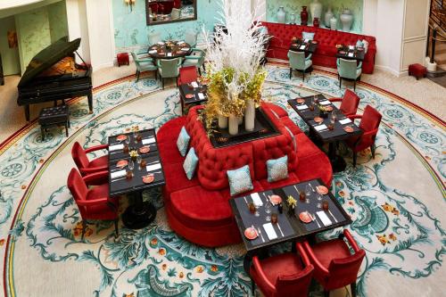 an overhead view of a restaurant with red chairs and tables at Shangri-La Paris in Paris