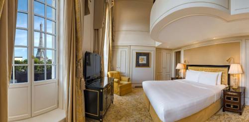 a hotel room with a bed and a window at Shangri-La Paris in Paris