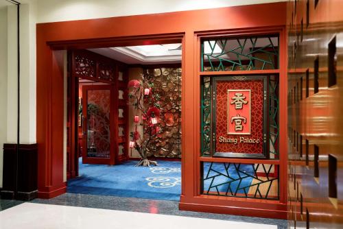 an entrance to a building with a sign on the door at Shangri-La Harbin in Harbin