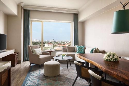 a living room with a couch and a table at Shangri-la Surabaya in Surabaya