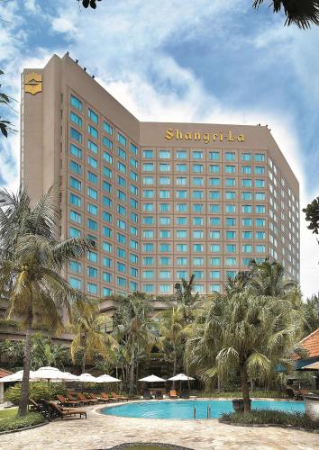 a large hotel with a swimming pool in front of it at Shangri-la Surabaya in Surabaya