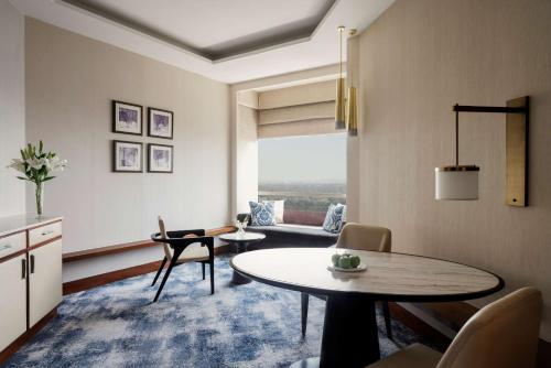 a living room with a table and a couch at Shangri-La Eros New Delhi in New Delhi