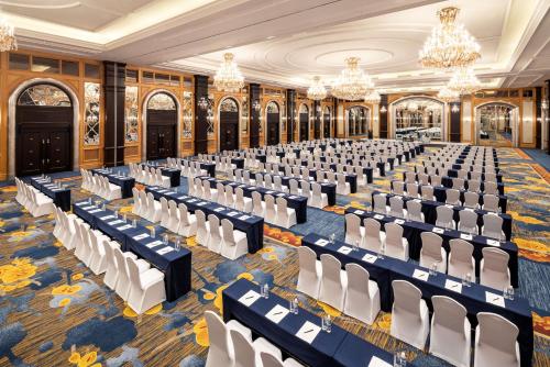 a hall with chairs and tables in a room with chandeliers at Shangri-La Harbin in Harbin