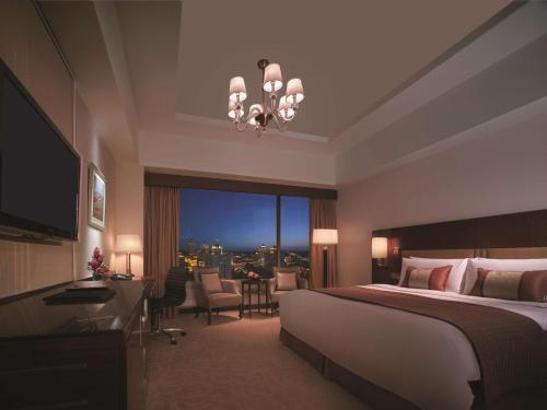 a bedroom with a bed and a view of a city at Shangri-La Manzhouli in Manzhouli