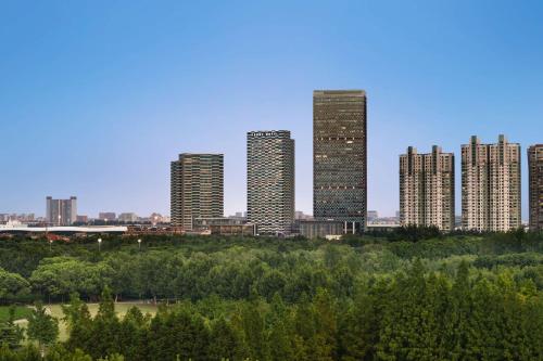 a group of tall buildings in a city at Kerry Hotel Pudong, Shanghai - Indoor Connecting to Shanghai New International Expo Centre in Shanghai