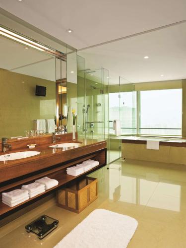 a large bathroom with a sink and a mirror at Kerry Hotel Pudong, Shanghai - Indoor Connecting to Shanghai New International Expo Centre in Shanghai