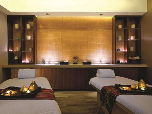 two beds in a room with candles on them at Kerry Hotel Pudong, Shanghai - Indoor Connecting to Shanghai New International Expo Centre in Shanghai
