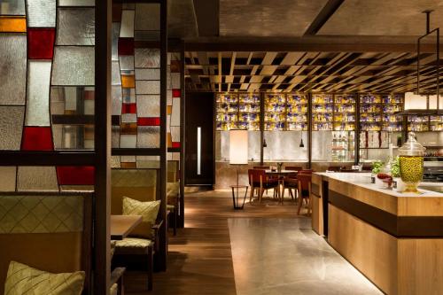 a restaurant with a bar and a dining room at Midtown Shangri-La, Hangzhou - around 5 minutes walking distance to West Lake in Hangzhou