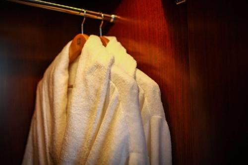a white robe is hanging on a rack at Shangri-La Tangshan in Tangshan