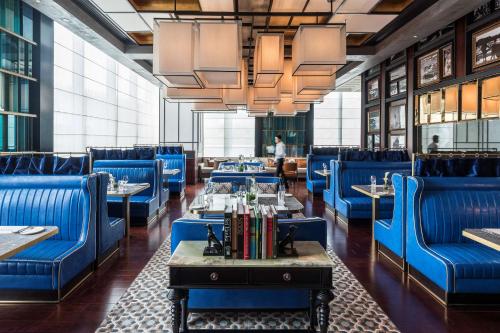 a dining room with blue chairs and tables at Shangri-La Colombo in Colombo