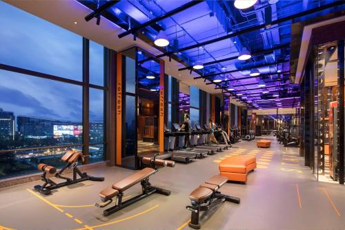 a gym with cardio equipment in a skyscraper at Shangri-La Jinan in Jinan