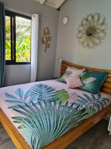 a bedroom with a bed with a plant on it at kokopoirier in Terre-de-Haut
