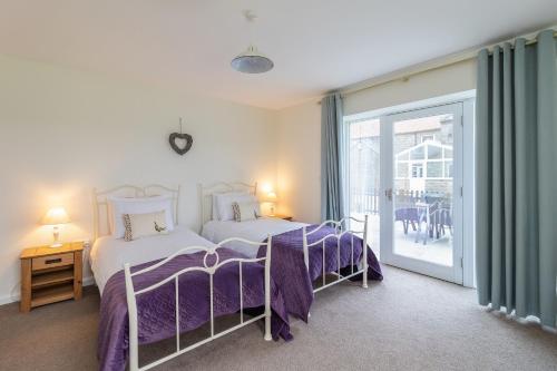 2 Betten in einem Zimmer mit Balkon in der Unterkunft The Grainary Cottages in Scarborough