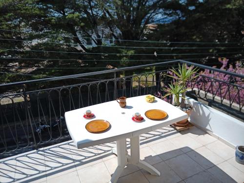 - une table blanche avec de la nourriture sur le balcon dans l'établissement T2 Terrasse vue mer, à Six-Fours-les-Plages