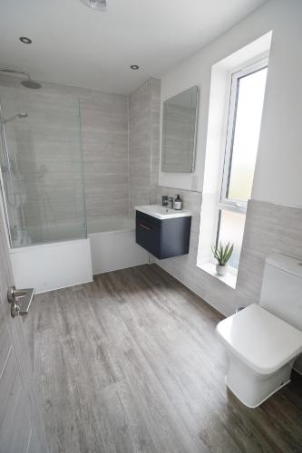 a bathroom with a shower and a toilet and a sink at 11 Breakwaters Way - Sandown in Sandown