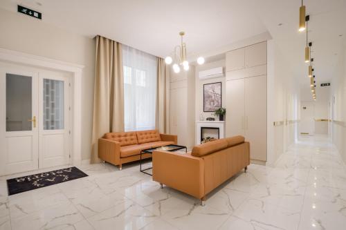 a living room with two couches and a fireplace at Astoria Boutique Suites- Best Location by BQA in Budapest