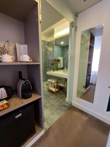 a bathroom with a walk in shower and a glass door at Augusta Boutique House in Lisbon
