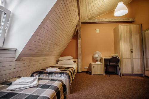 a hotel room with two beds and a staircase at Guest House "Arkhistratyg" in Lviv