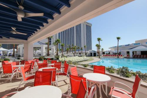 a patio with tables and chairs and a swimming pool at Westgate Las Vegas Resort and Casino in Las Vegas