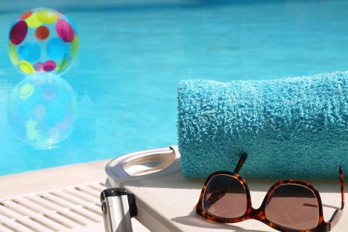 a pair of sunglasses sitting next to a pool at Maison Metel in Kontokali