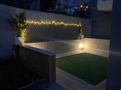 a small garden with lights and a small lawn at eliTe deluxe 1 in Kavala