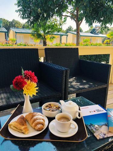a table with coffee and croissants and a cup of coffee at MCM Camping in Ulcinj