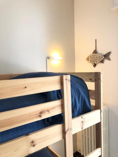 a bedroom with a wooden bunk bed with blue sheets at Un Passo dal Mare in Zoagli