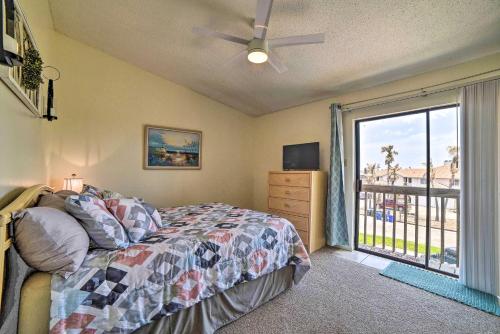 a bedroom with a bed and a window with a balcony at Canalfront Retreat with Dock, Hot Tub and Pool Access! in Corpus Christi
