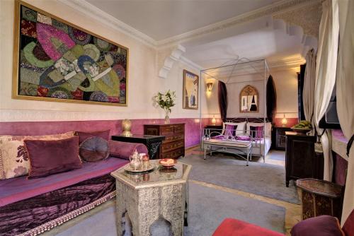 a living room with a purple couch and a table at Riad Dar El Souk in Marrakesh