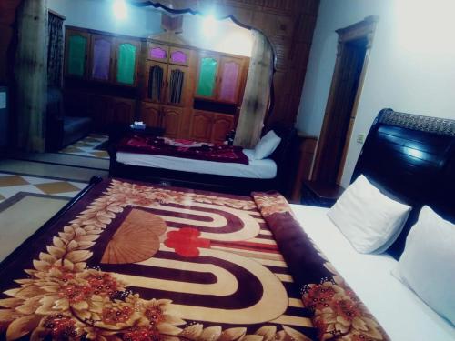 a bedroom with a bed with a carpet on it at Butt Lodges 3 in Islamabad