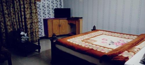 a bedroom with a bed and a television in it at Butt Lodges 3 in Islamabad