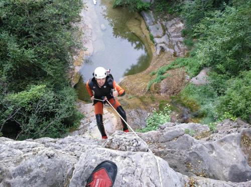 a person standing on a rock with a rope at Hotel Río Escabas, Serranía de Cuenca in Cañamares