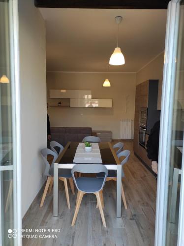 a dining room and kitchen with a table and chairs at Profumo di Jonio in Siderno Marina