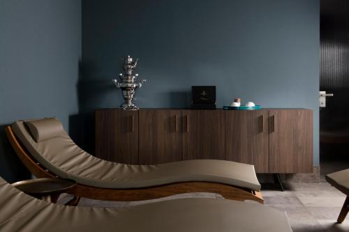a living room with a couch and a wooden cabinet at Coast Hotel & Spa - Adults Only Aperto tutto l'anno in Milano Marittima