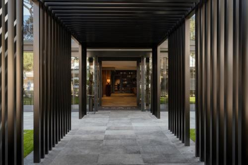 a hallway leading into a building with columns at Coast Hotel & Spa - Adults Only Aperto tutto l'anno in Milano Marittima