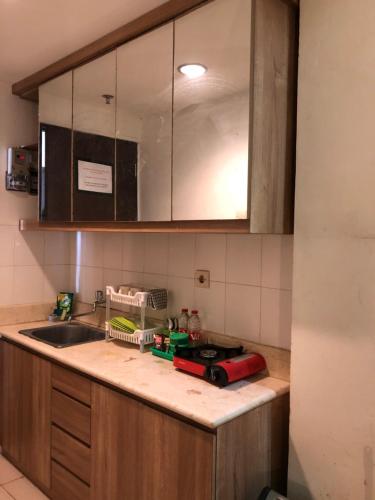 a kitchen with a sink and a counter top at Apartemen Malang in Malang