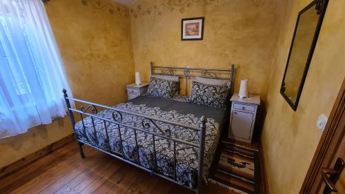 a bedroom with a metal bed in a room at House Avena with spa & gym in Labin