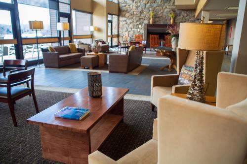 a lobby with couches and a table and chairs at The Terrace Hotel at Lake Junaluska in Lake Junaluska