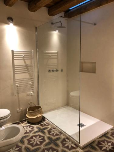 een badkamer met een douche, een toilet en een wastafel bij O'scià Loft in Noto
