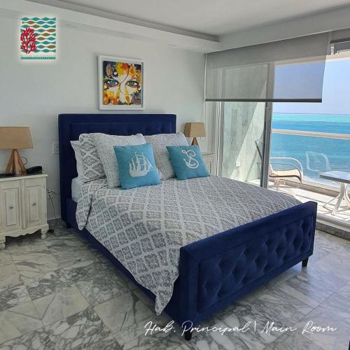 聖安德烈斯的住宿－Hermosos Apartamentos Frente Al Mar，卧室内的蓝色床和蓝色枕头