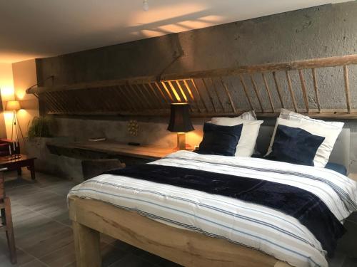 a bedroom with a large bed with a wooden headboard at Matin de Saône in Fontaines-Saint-Martin