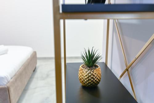 a pineapple sitting on a table in a room at Lake Mansion Boutique Apartments in Tiberias