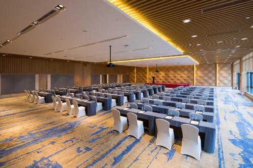 a large room with rows of chairs in it at Holiday Inn Kunshan Huaqiao by IHG in Kunshan