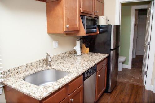 a kitchen with a sink and a stainless steel refrigerator at InnSeason Resorts HarborWalk in Falmouth