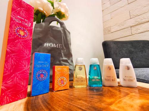 a table with three bottles of soap and a bag at 1st Luxury Warehouse in Cancún