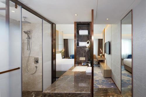 a hotel room with a shower and a bathroom at Park Plaza Beijing Science Park in Beijing