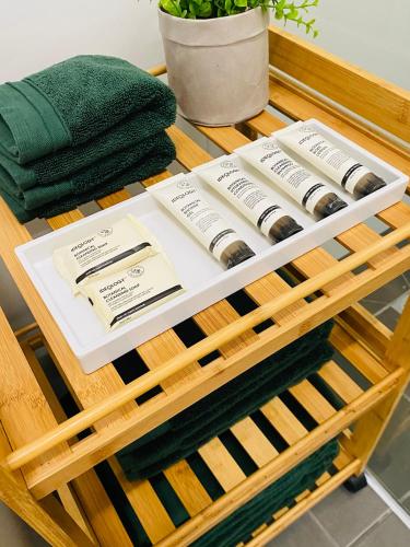 a wooden table with a green towel and towels on it at The Morrison Stables in Geelong