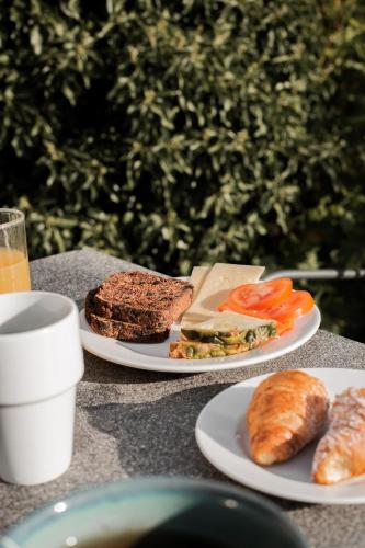 two plates with sandwiches and croissants on a table at Clarion Hotel Wisby in Visby