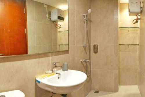 a bathroom with a sink and a shower at Lovina 1205 at Pollux Meisterstadt in Batam Center