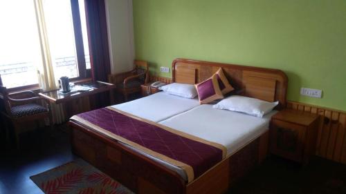 Postel nebo postele na pokoji v ubytování Vijay Mount View